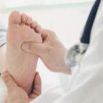 Doctor giving a patient foot treatment